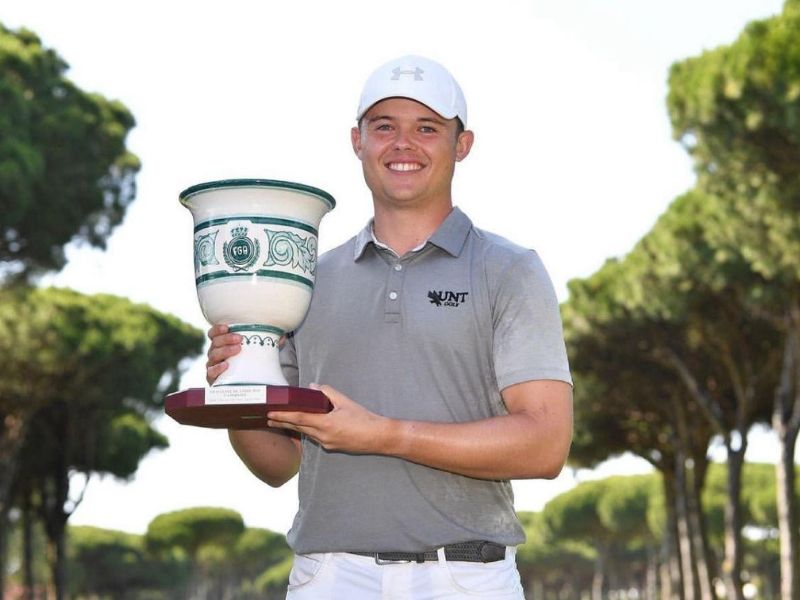 Kristof Ulenaers holding a golf tournament trophy after an international victory