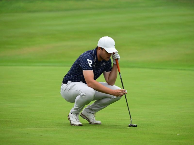 Kristof Ulenaers reading a putt on the green during a professional golf tournament